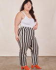 Side view of Petite Black Striped Work Pants in White and vintage off-white Cami on Ashley