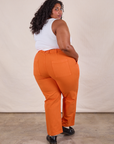 Angled back view of Work Pants in Construction Orange and Cropped Tank in Vintage Tee Off-White on Morgan