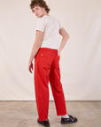 Angled back view of Work Pants in Mustang Red and Burly Tee in Vintage Tee Off-White