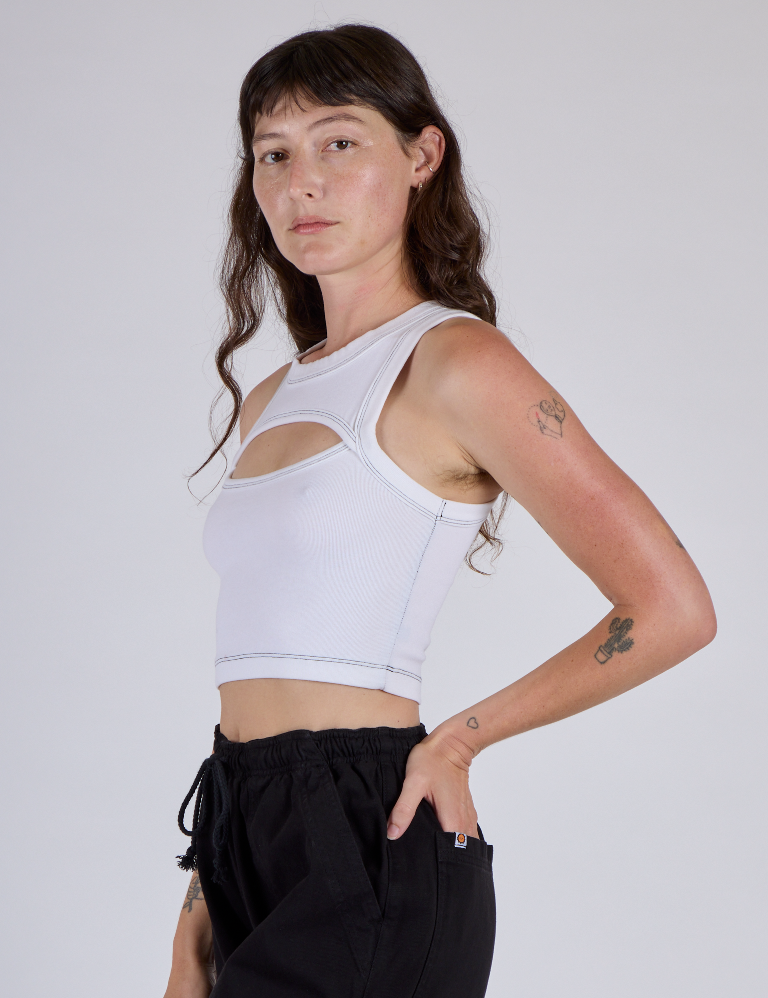 Side View of Alex wearing the Vintage Tee White Porthole Tank