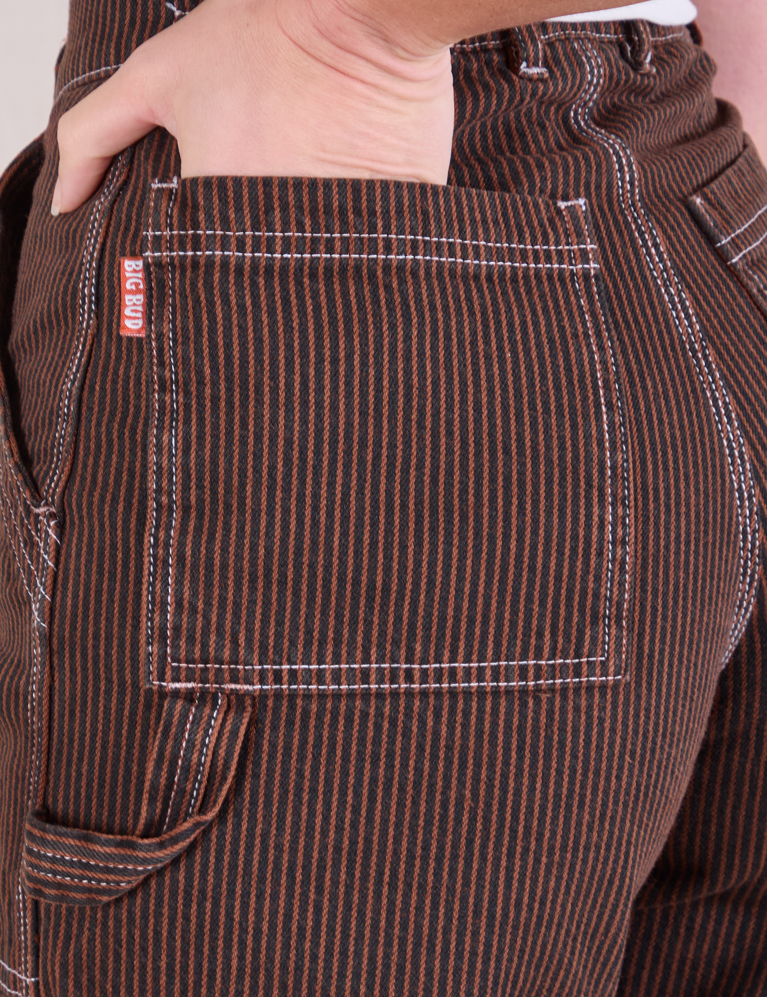 Close up of Alex&#39;s hand in the back pocket of Railroad Carpenter Shorts in Fudgesicle Brown