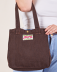 Railroad Shopper Tote in fudgesicle brown worn on arm of model