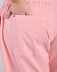 Close up of Juliet's hand in the back pocket of Drop Pocket Cargo Pants in Baby Pink