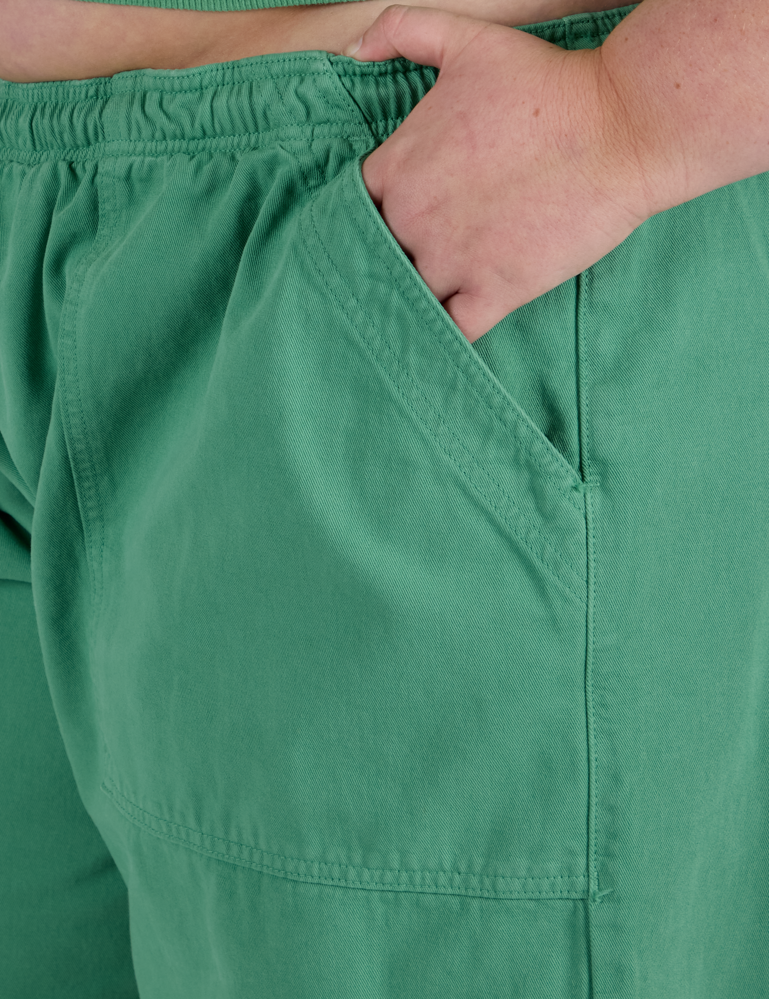 Close up of Juliet's hand in the front pocket of Drop Pocket Cargo Pants in Seafoam Green
