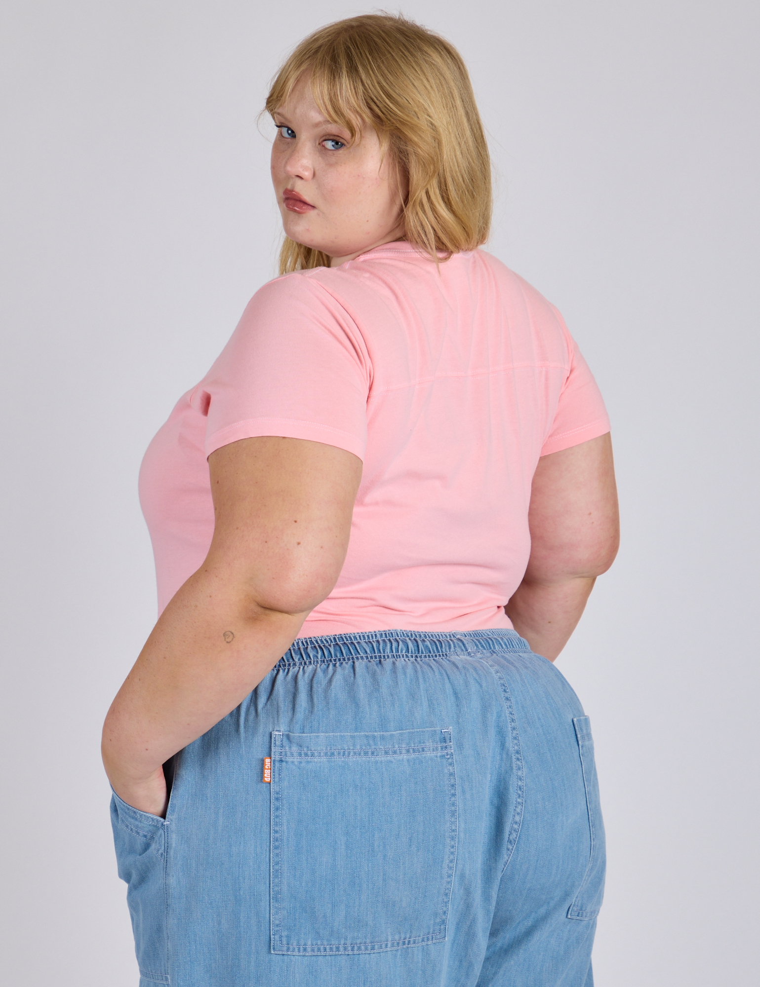 Jr. Varsity Tee in Baby Pink angled back view on Juliet