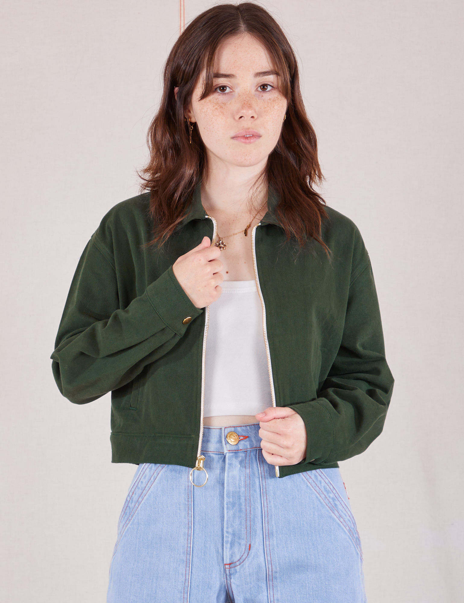 Hana is wearing Ricky Jacket in Swamp Green with a vintage off-white tee Cami underneath