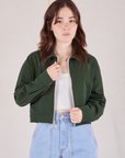 Hana is wearing Ricky Jacket in Swamp Green with a vintage off-white tee Cami underneath