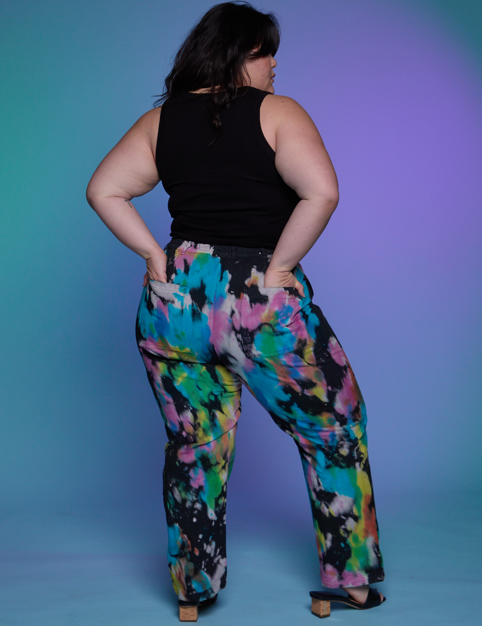 Back view of Work Pants in Rainbow Magic Waters and black Cropped Tank on Ashley