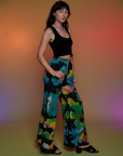 Side view of Tie Dyed Wide Leg Sweat Pants and black Cropped Tank on Alex
