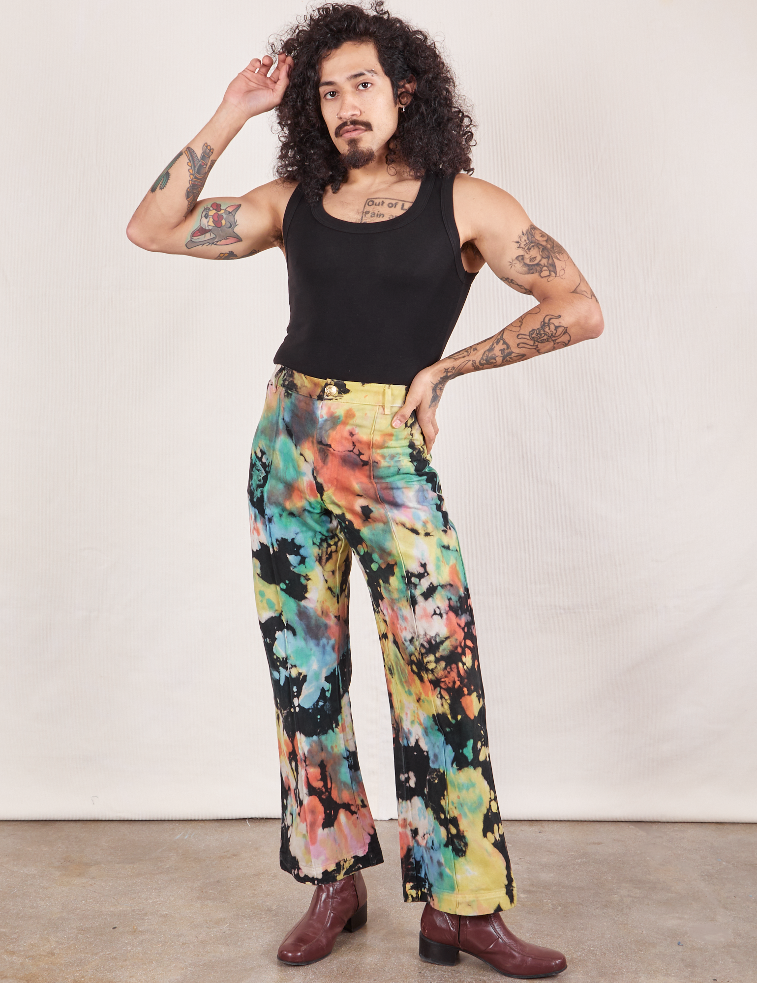 Jesse is 5&#39;8&quot; and wearing XS Western Pants in Rainbow Magic Waters paired with black Tank Top