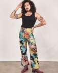 Jesse is 5'8" and wearing XS Western Pants in Rainbow Magic Waters paired with black Tank Top