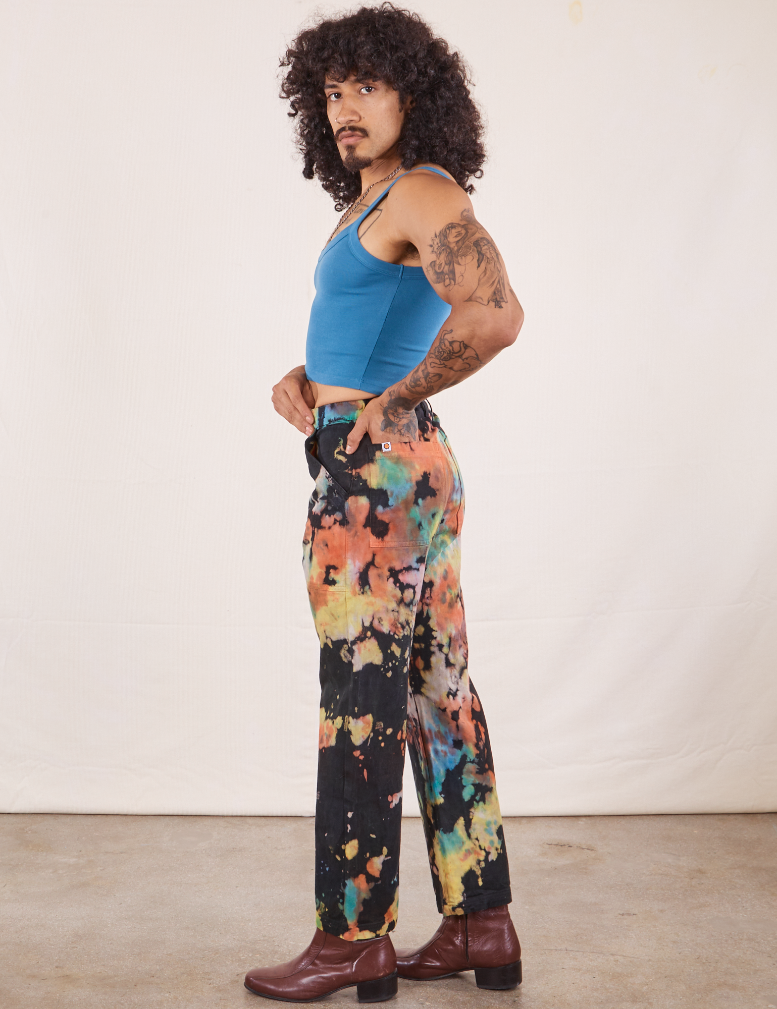 Side view of Rainbow Magic Waters Work Pants and marine blue Cropped Cami worn by Jesse