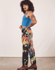 Side view of Rainbow Magic Waters Work Pants and marine blue Cropped Cami worn by Jesse