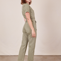 Angled back view of Short Sleeve Jumpsuit in Khaki Grey worn by Alex