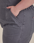 Close up of Ashley's hand in the front pocket of Short Sleeve Jumpsuit in Washed Grey