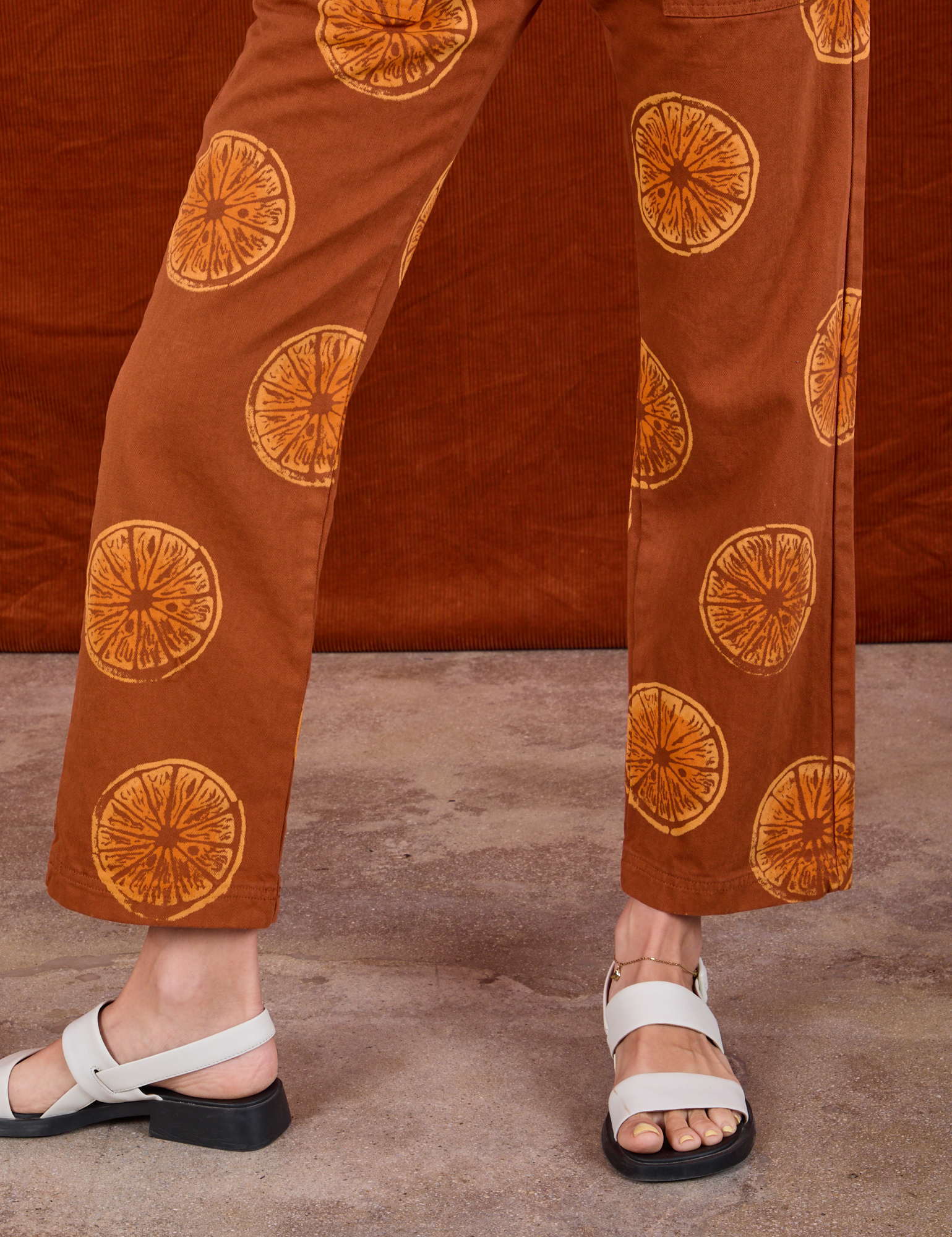 Paintstamped Work Pants in Orange pant leg close up on Madeline