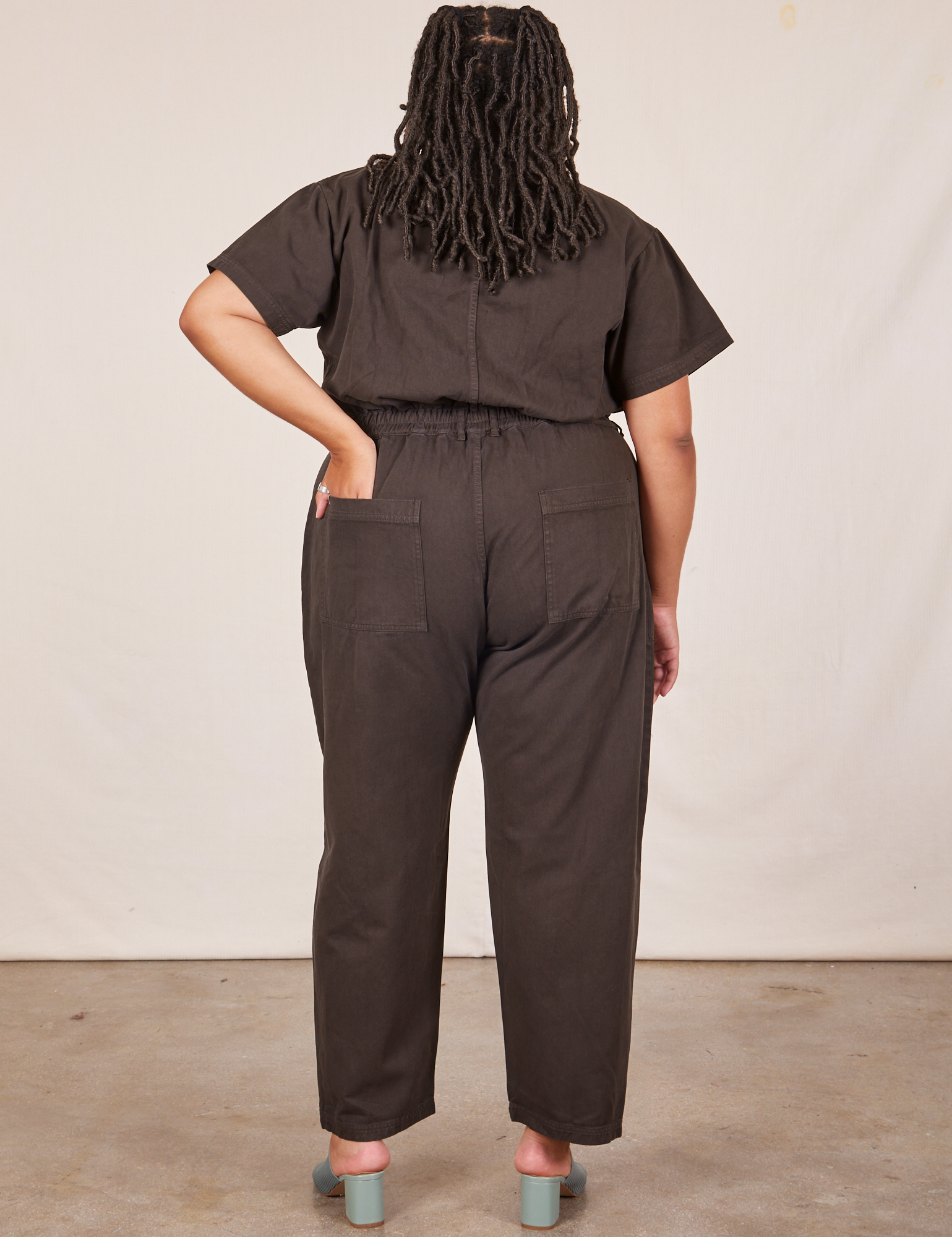 Back view of Short Sleeve Jumpsuit in Espresso Brown worn by Alicia
