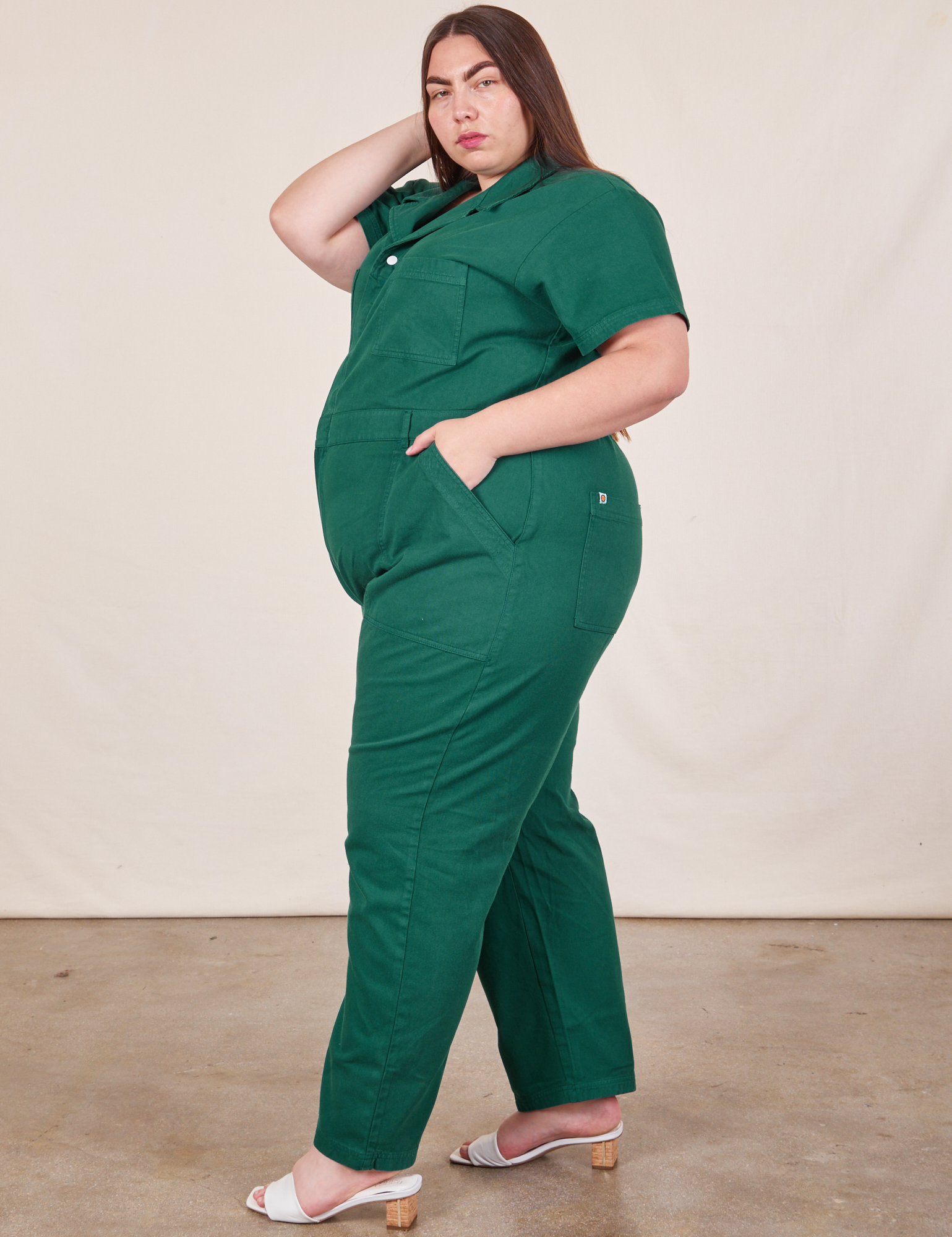 Side view of Short Sleeve Jumpsuit in Hunter Green worn by Marielena