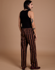 Back view of Black Stripe Work Pants in Fudgesicle Brown and black Cropped Tank on Anthony