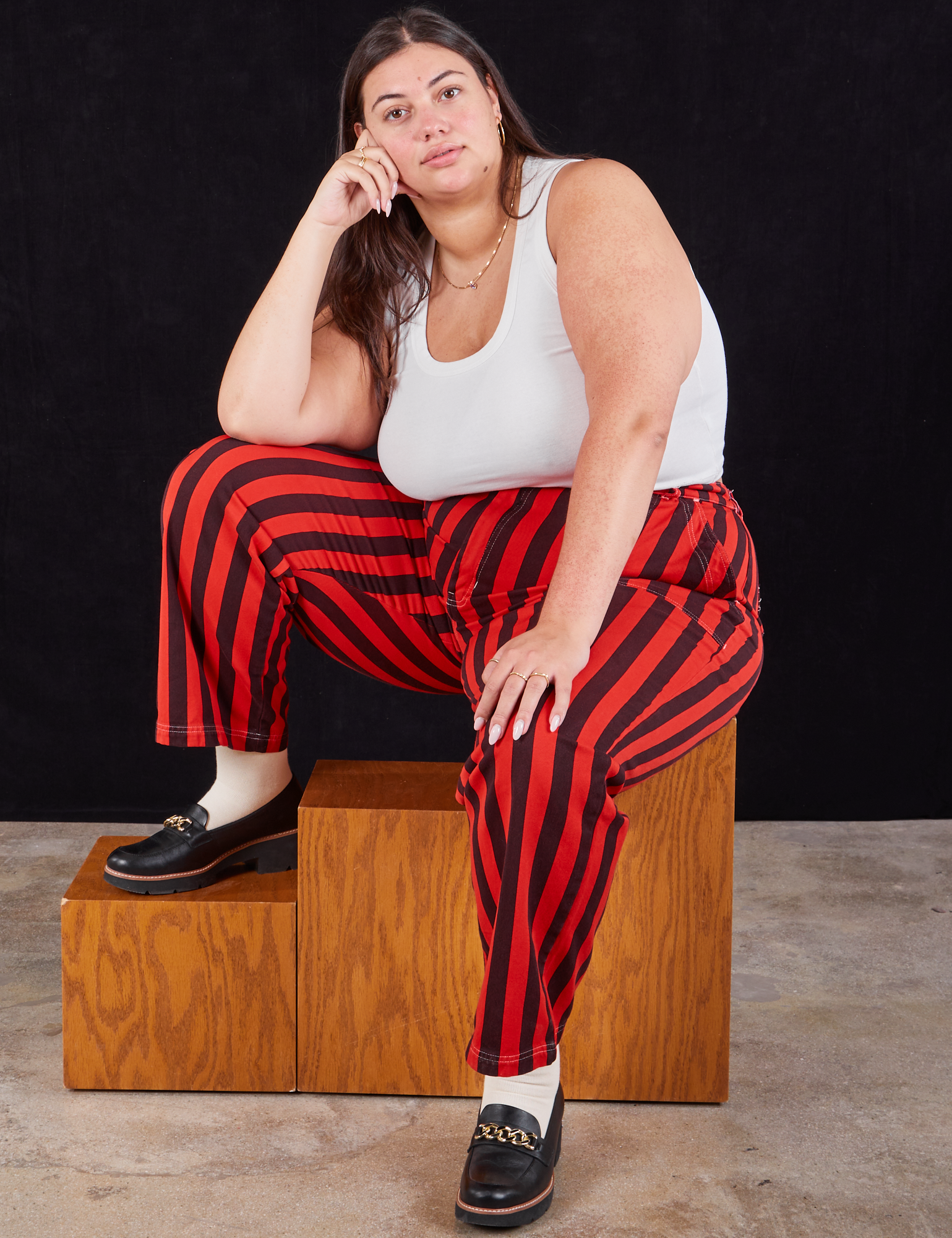 Katie is wearing Black Stripe Work Pants in Mustang Red and Cropped Tank in vintage tee off-white