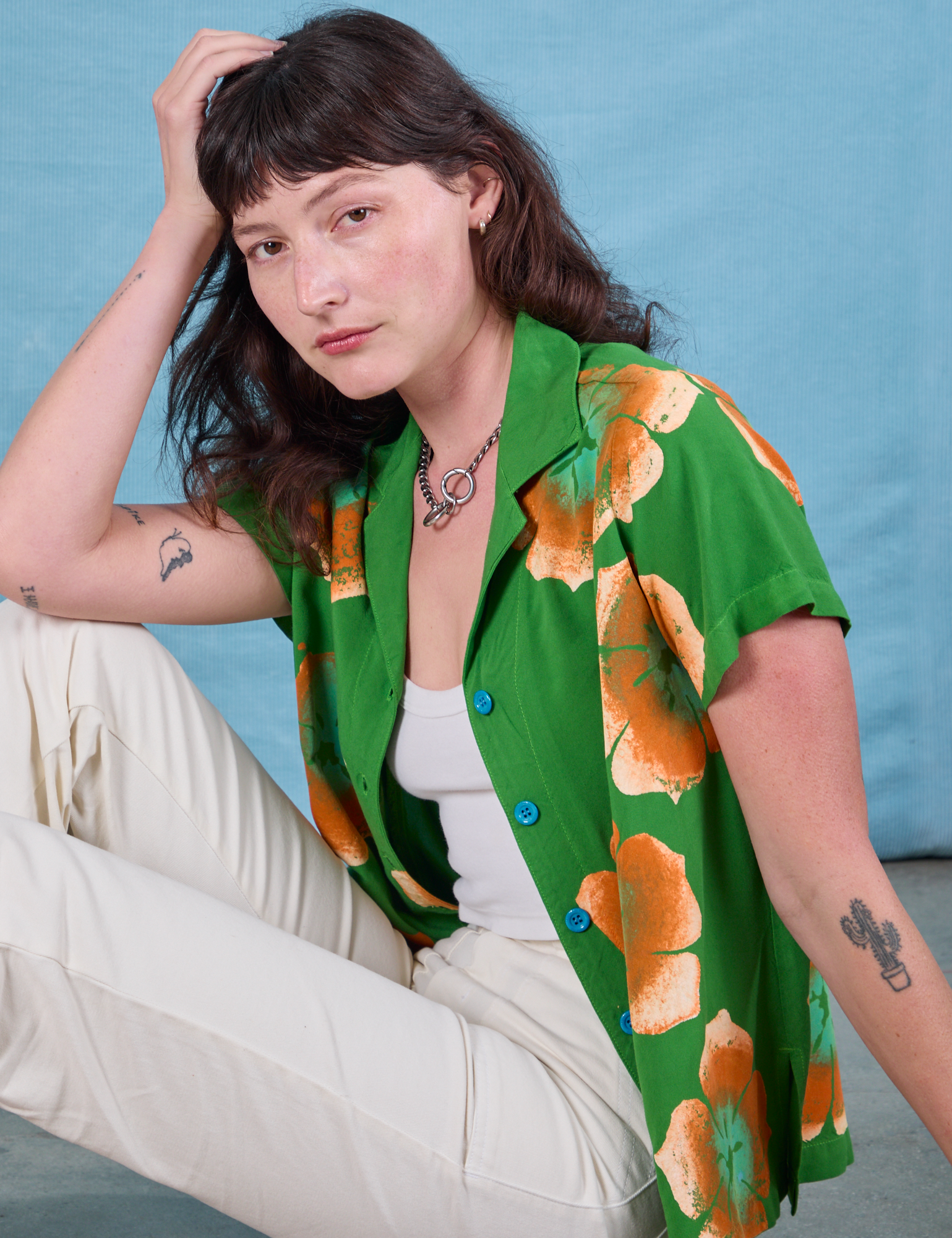 Alex is wearing Paintstamped Pantry Button-Up in Kelly Green