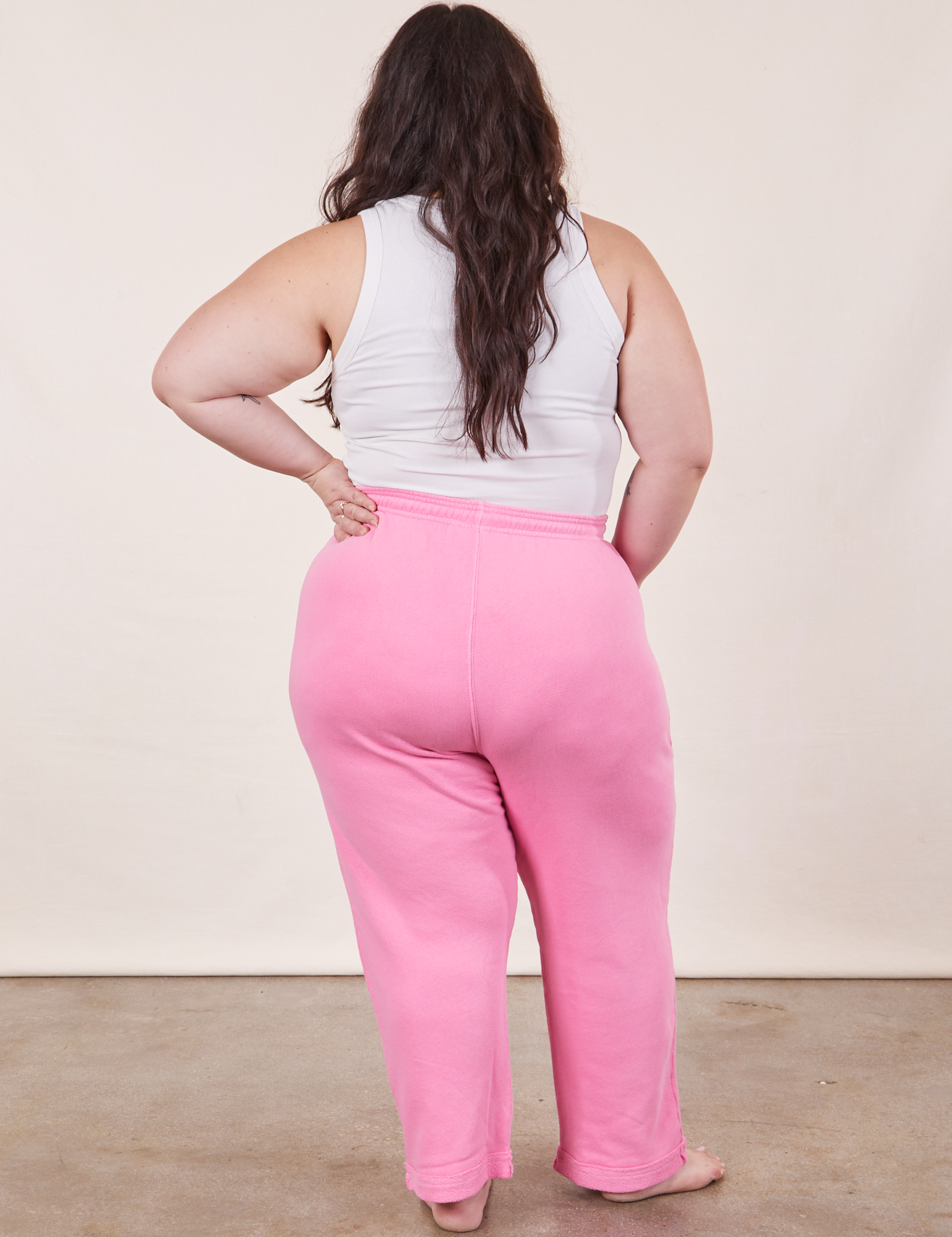 Back view of Cropped Rolled Cuff Sweatpants in Bubblegum Pink and vintage off-white Cropped Tank Top on Ashley