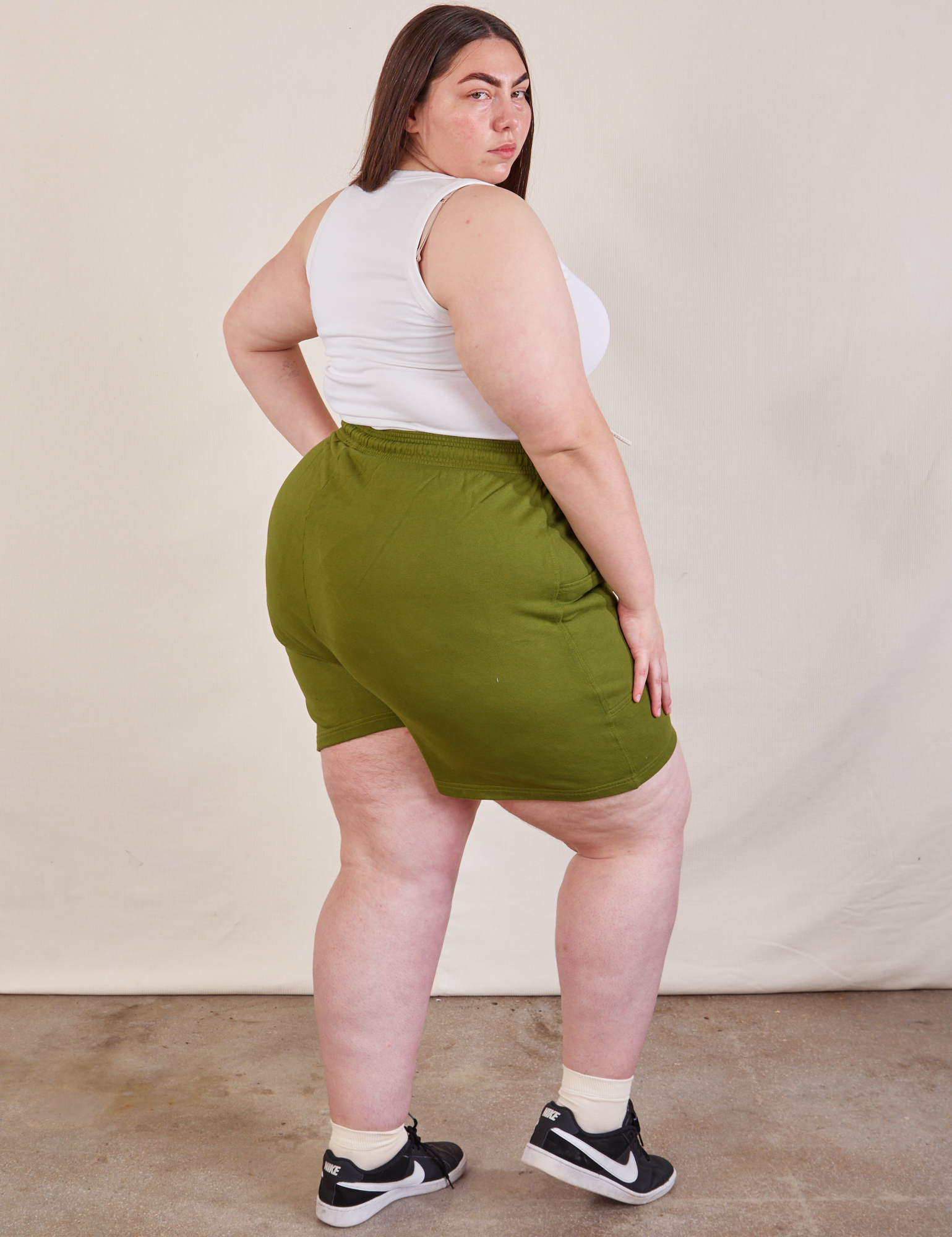 Angled back view of Lightweight Sweat Shorts in Summer Olive and Cropped Tank in vintage tee off-white on Marielena