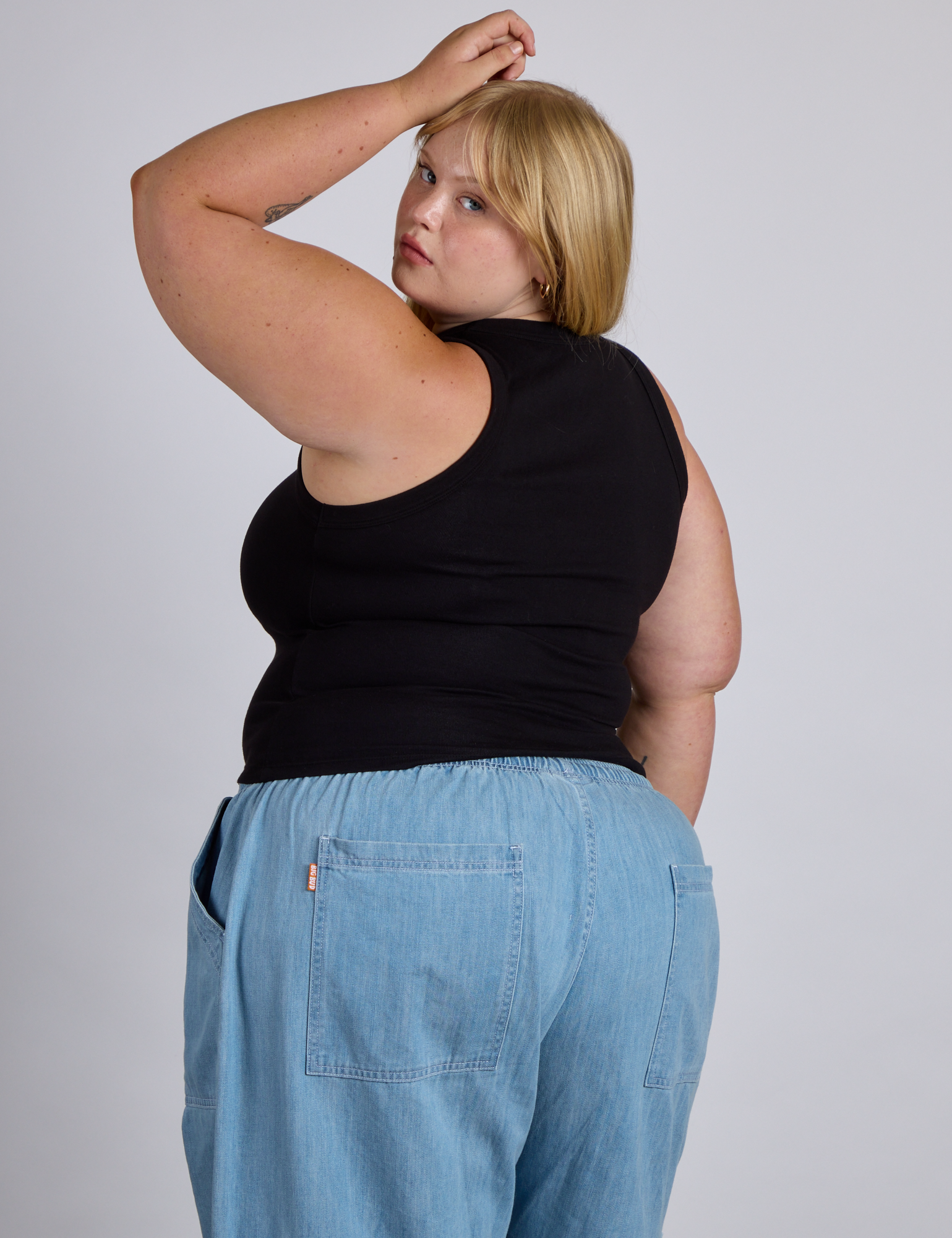 Angled back view of The Tank Top in Basic Black on Juliet