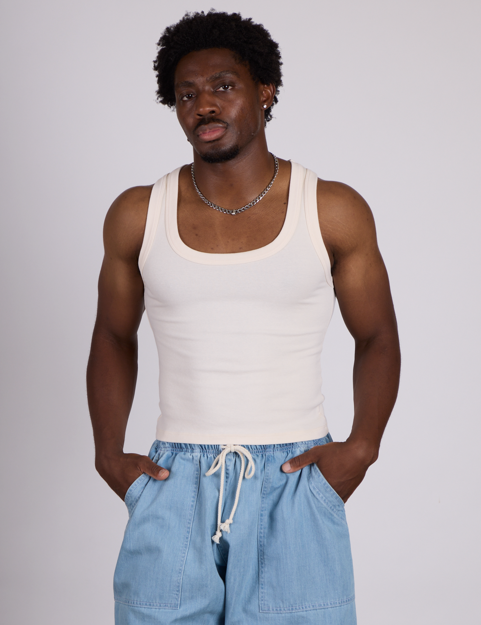 Isaac is 5’10” and wearing M The Tank Top in Vintage Tee Off-White