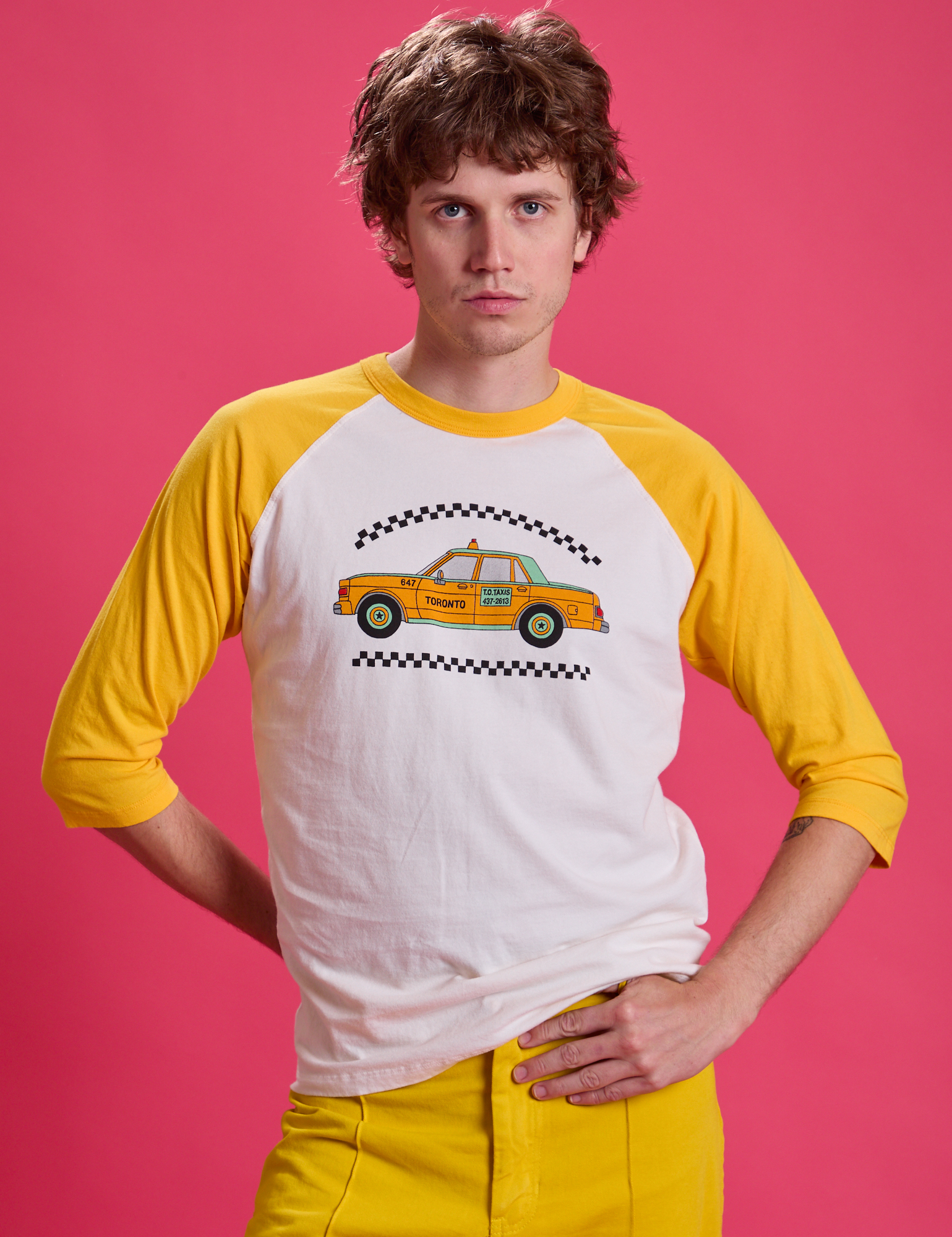 Quinn is 6&#39;3&quot; and wearing M Taxi Raglan Tee in Toronto