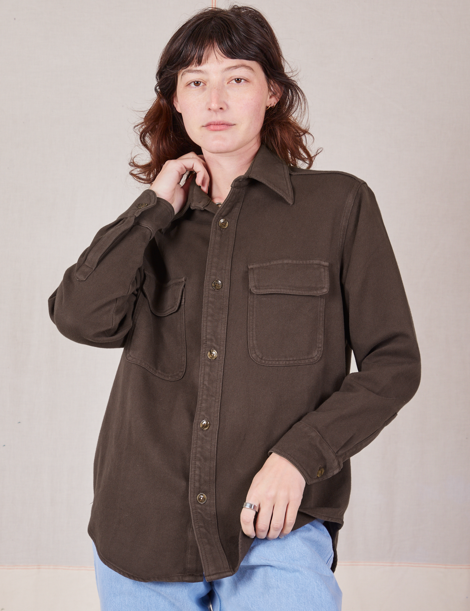 Alex is wearing a buttoned up Flannel Overshirt in Espresso Brown