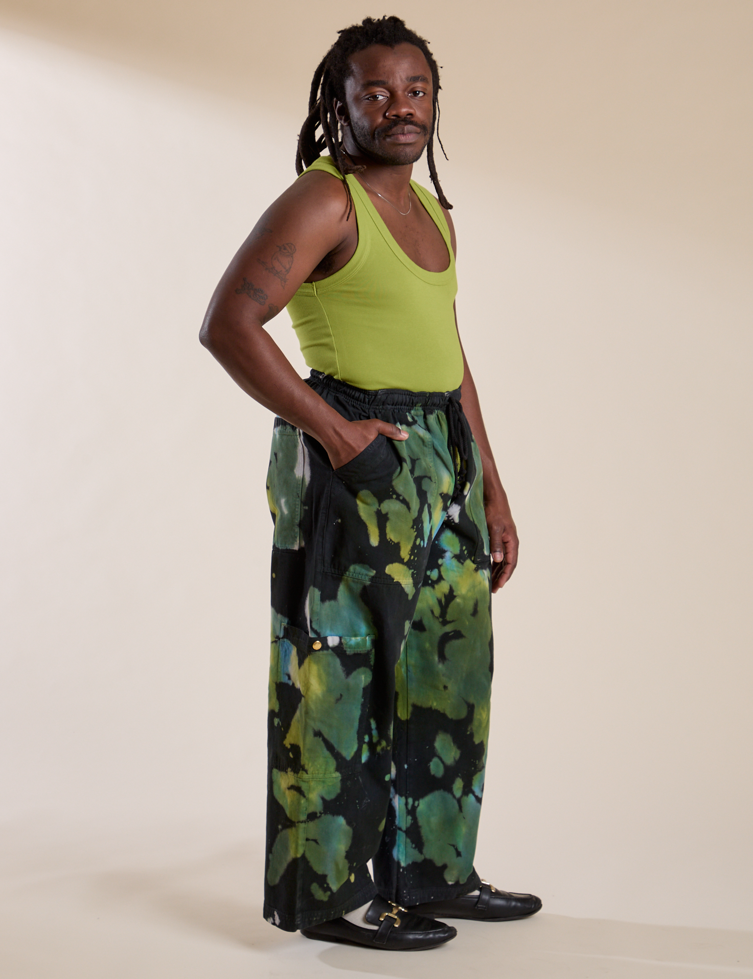 Side view of Magic Waters Drop Pocket Pants in Green Pool and gross green Cropped Tank on Demi
