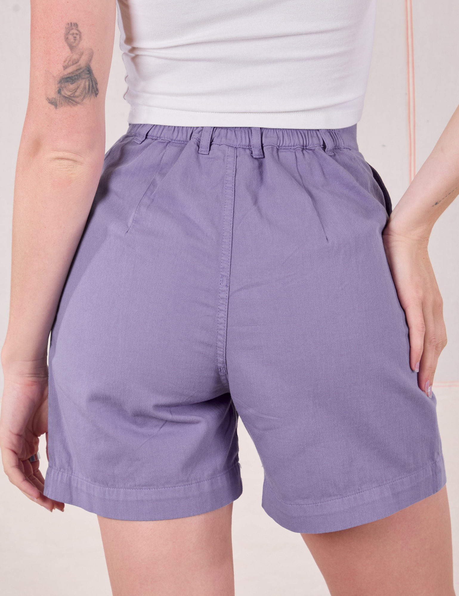 Trouser Shorts in Faded Grape back view close up on Alex