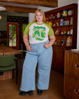 Juliet is wearing Short Sleeve Raglan Tee in Snap Peas tucked into light wash Indigo Wide Leg Trousers