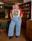 Juliet is wearing Short Sleeve Raglan Tee in Tomatoes tucked into light wash Indigo Wide Leg Trousers