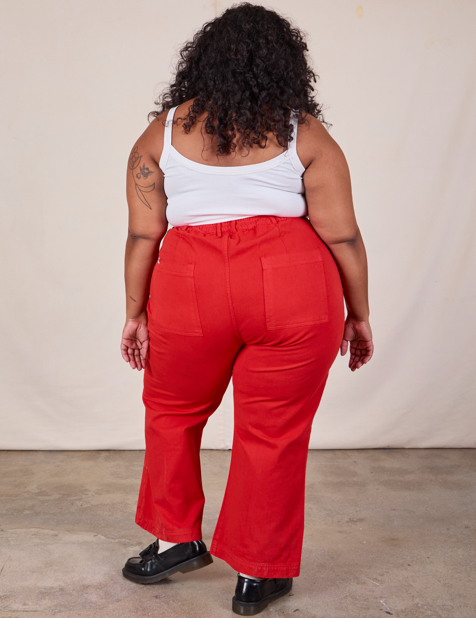 Back view of Western Pants in Mustang Red and Cropped Cami in Vintage Tee Off-White