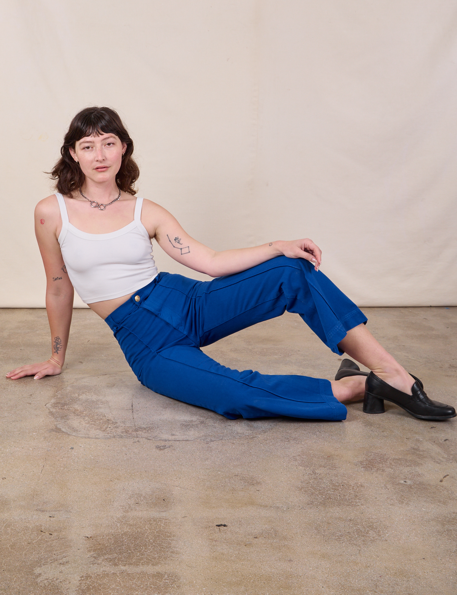 Alex is wearing Western Pants in Royal Blue and a Cami in Vintage Tee Off-White