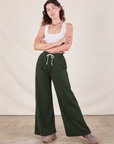 Alex is 5'8" and wearing P Wide Leg Sweat Pants in Swamp Green