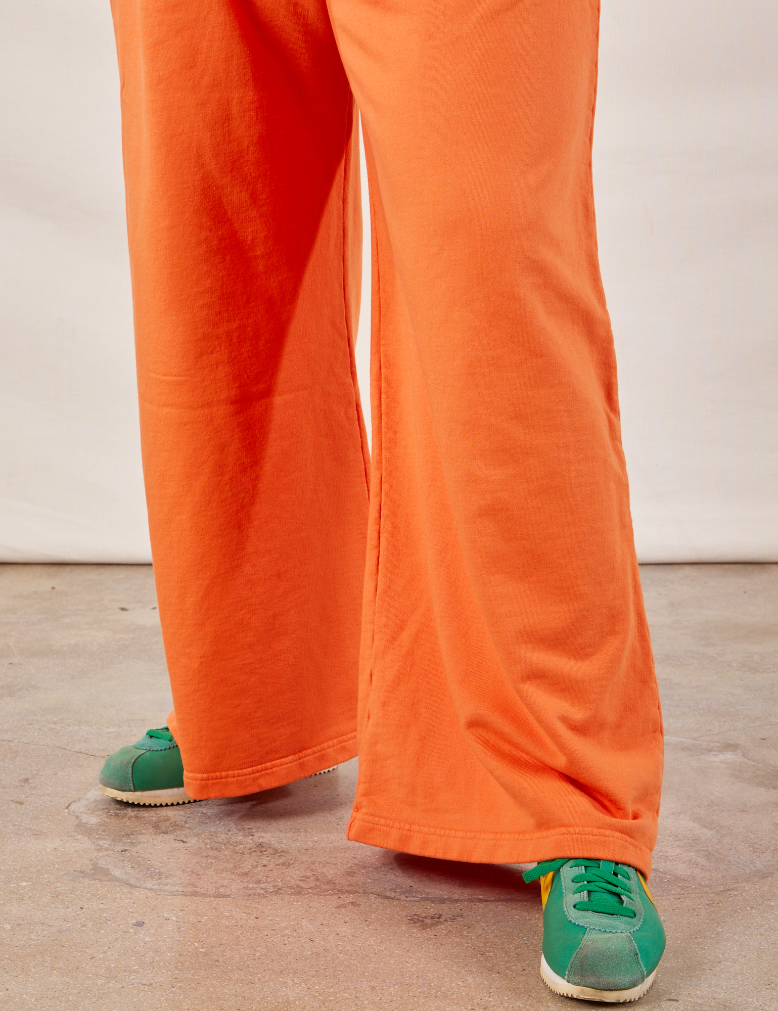 Wide Leg Sweat Pants in Sunset Orange pant leg close up on Ryan