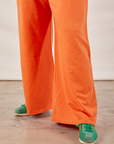 Wide Leg Sweat Pants in Sunset Orange pant leg close up on Ryan