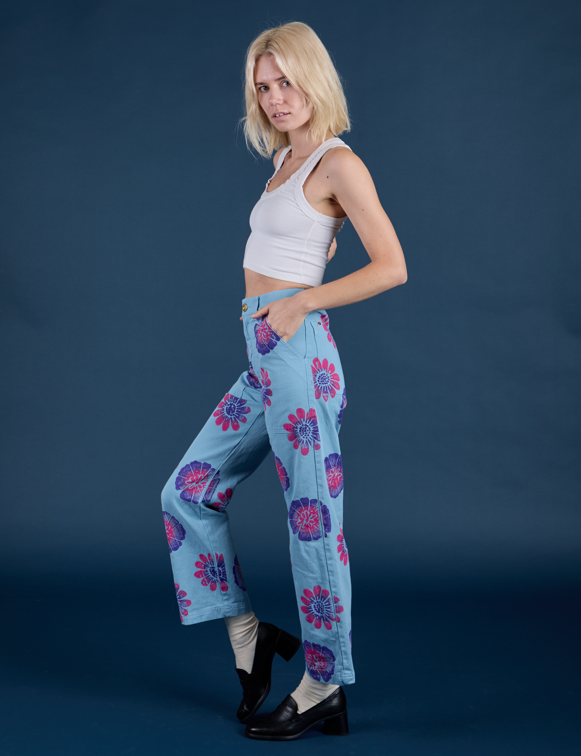Side view of Floral Painted Work Pants in Blue and Cropped Tank in Vintage Tee White on Madeline