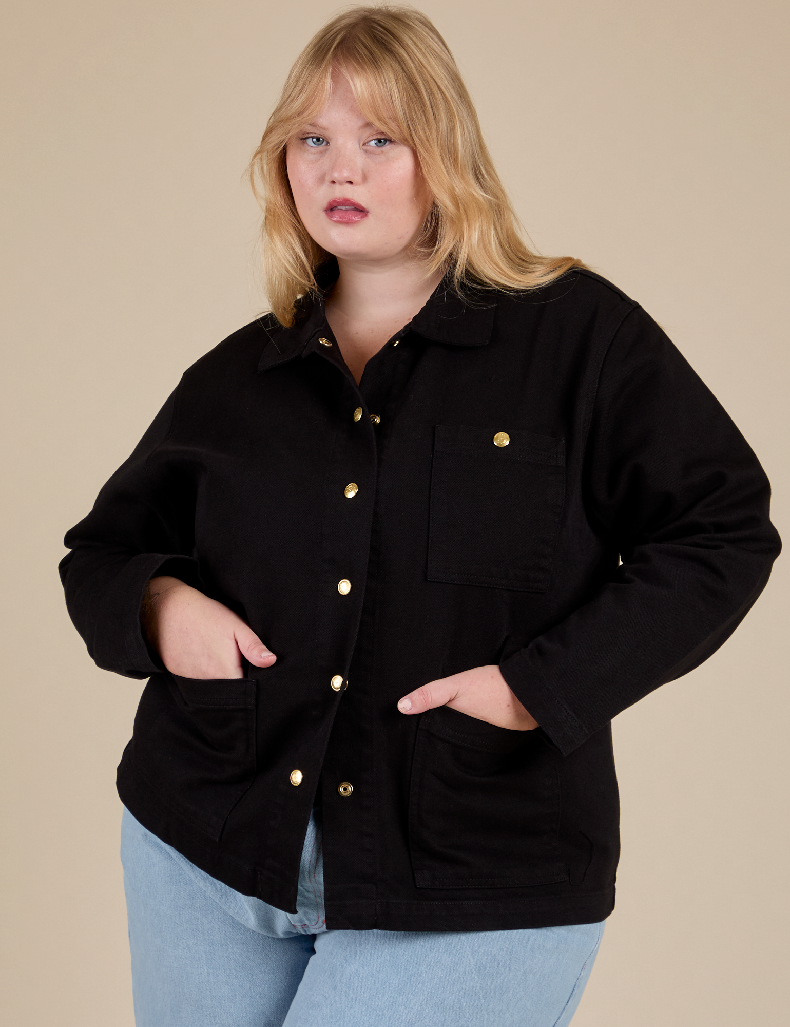 Juliet is wearing a buttoned up Work Jacket in Basic Black