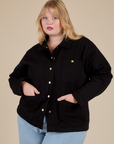 Juliet is wearing a buttoned up Work Jacket in Basic Black