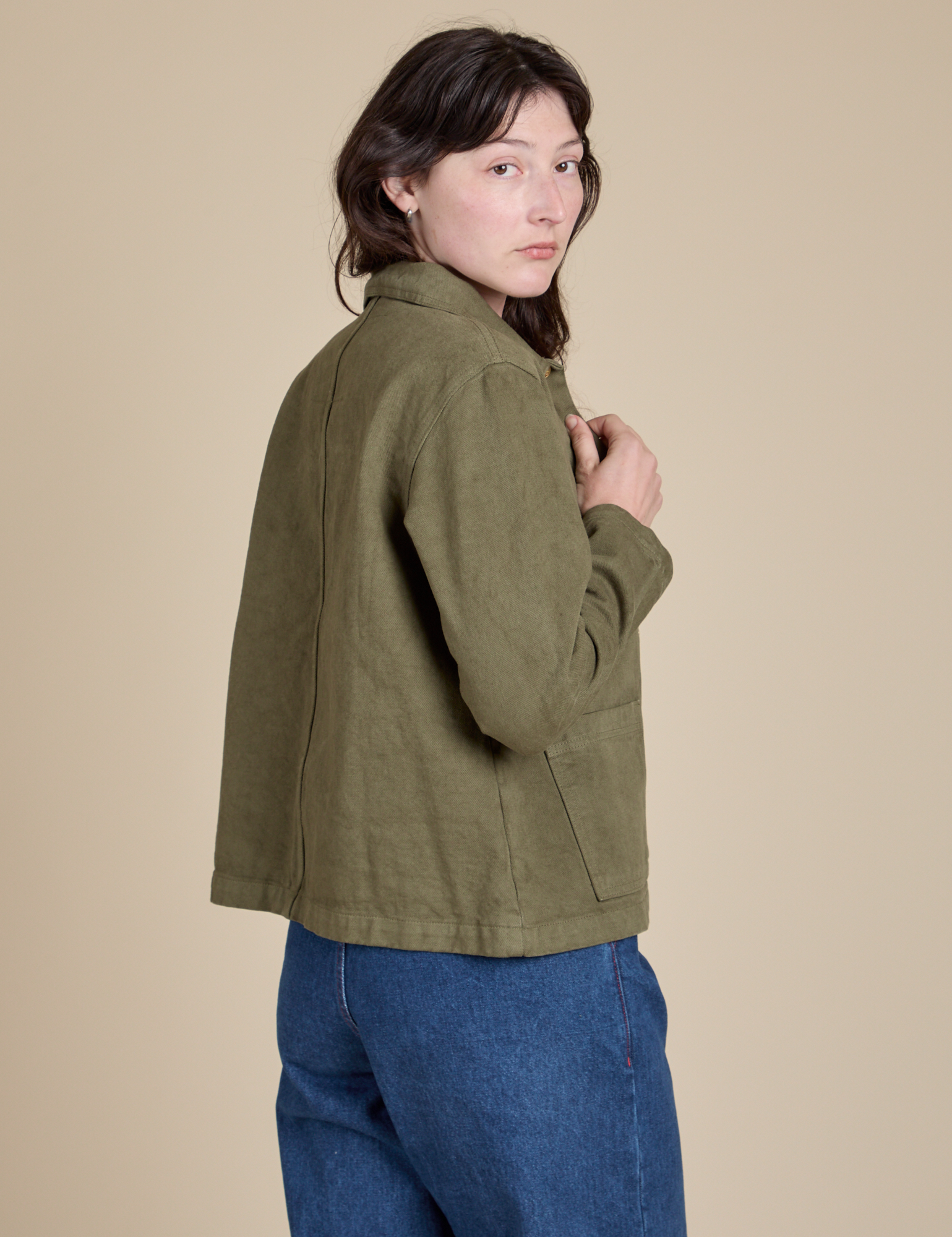 Angled back view of Denim Work Jacket in Surplus Green on Alex