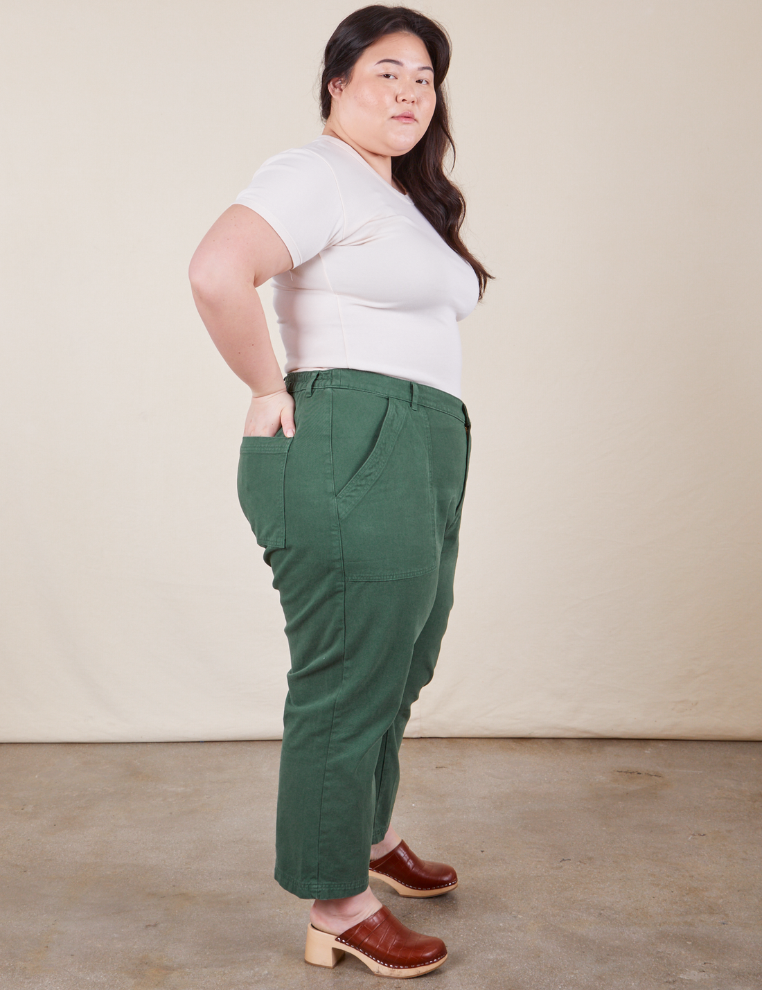 Work Pants in Dark Emerald Green side view on Ashley wearing vintage off-white Baby Tee