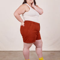 Side view of Classic Work Shorts in Paprika and vintage off-white Tank Top worn by Ashley