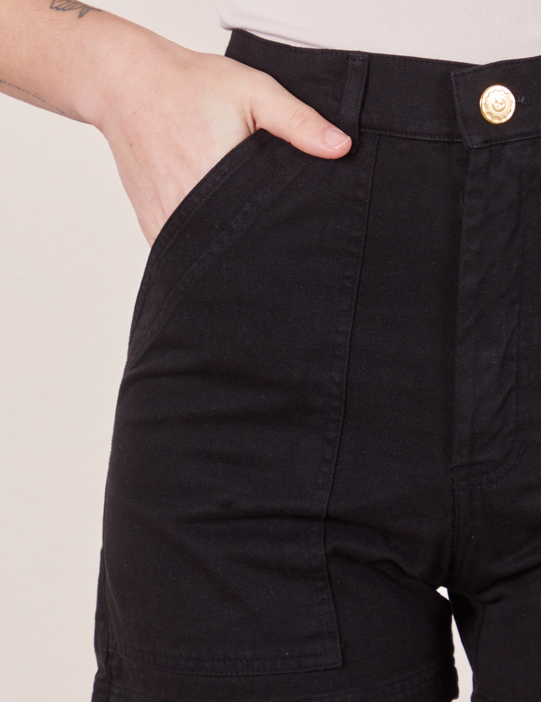 Classic Work Shorts in Basic Black front pocket close up on Alex with hand in pocket