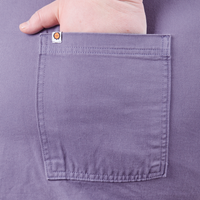 Catie has her hand in the back pocket of the Classic Work Shorts in Faded Grape