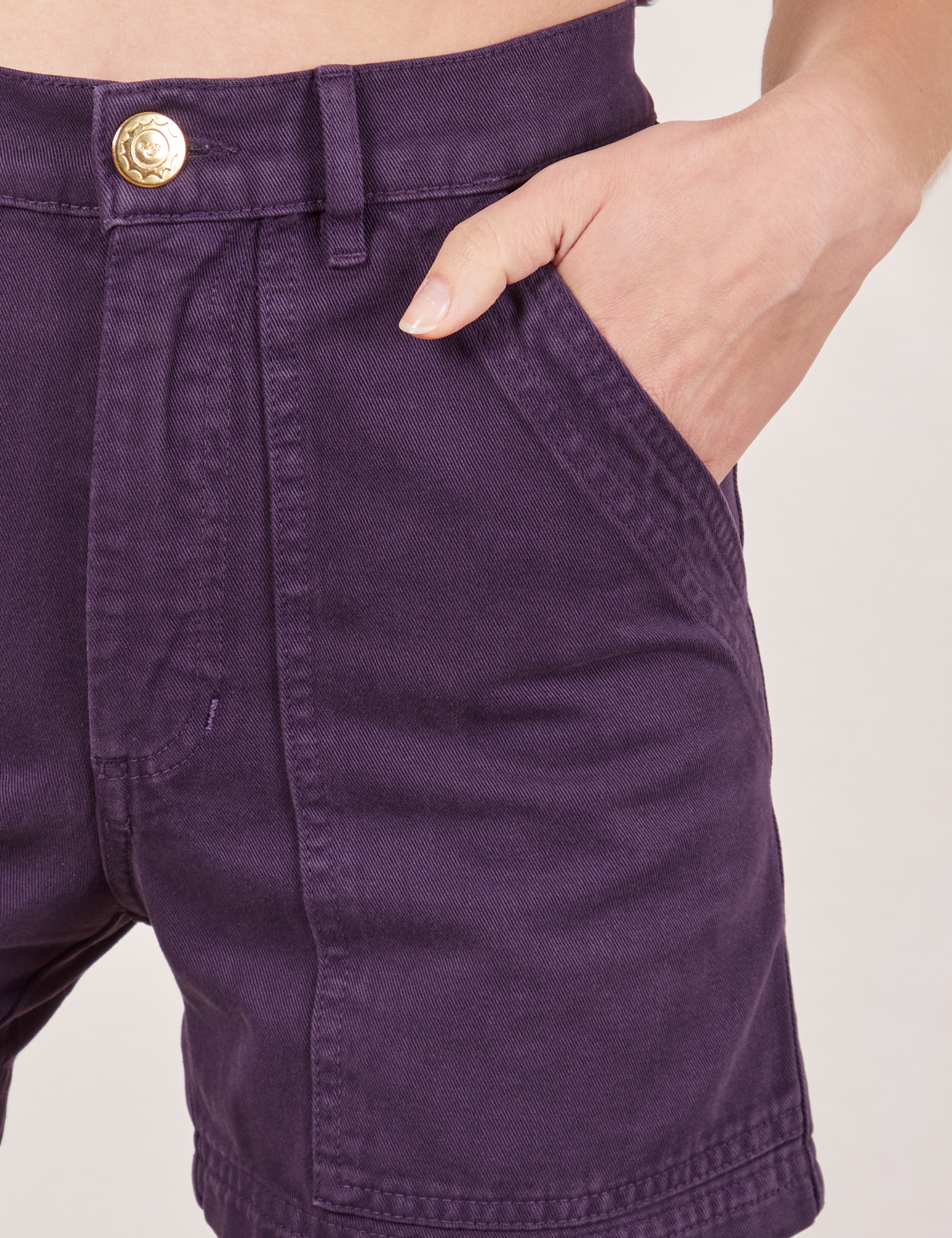 Classic Work Shorts in Nebula Purple front pocket close up. Madeline has her hand in the pocket.