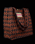 Angled view of Shopper Tote in Halloween Eyes